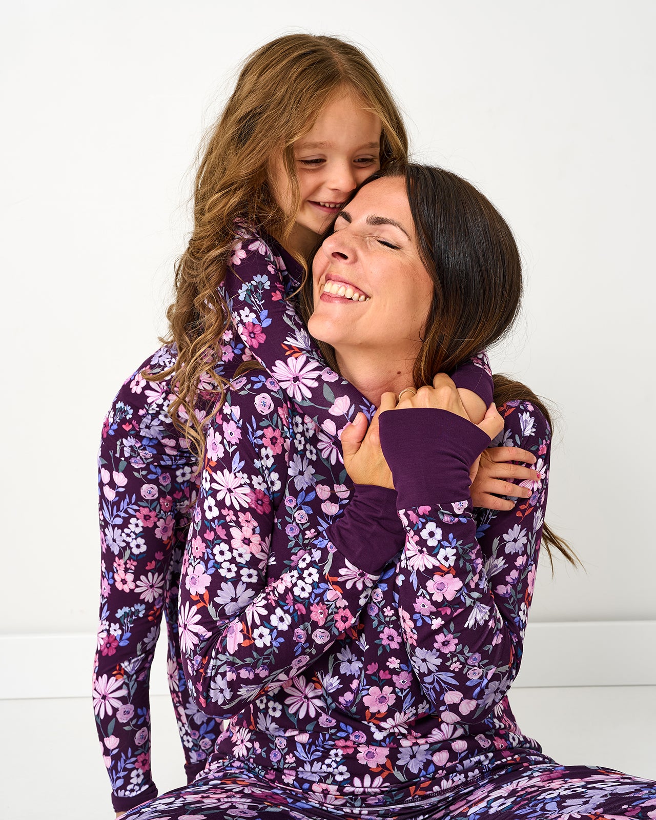 Mother and daughter wearing matching Violet Meadow floral pajamas