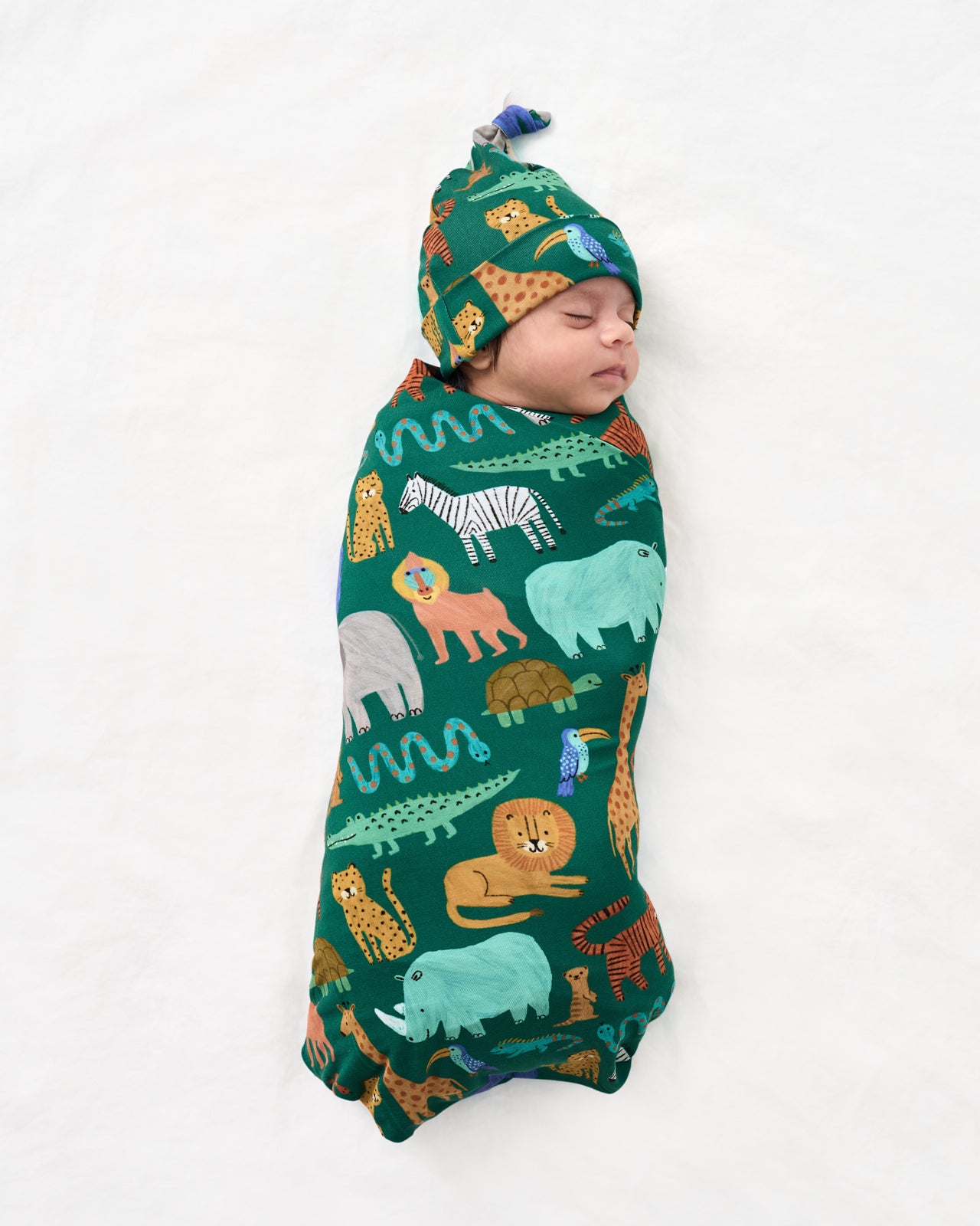 Aerial view of baby swaddled the the Wild Zoo Swaddle & Hat Set