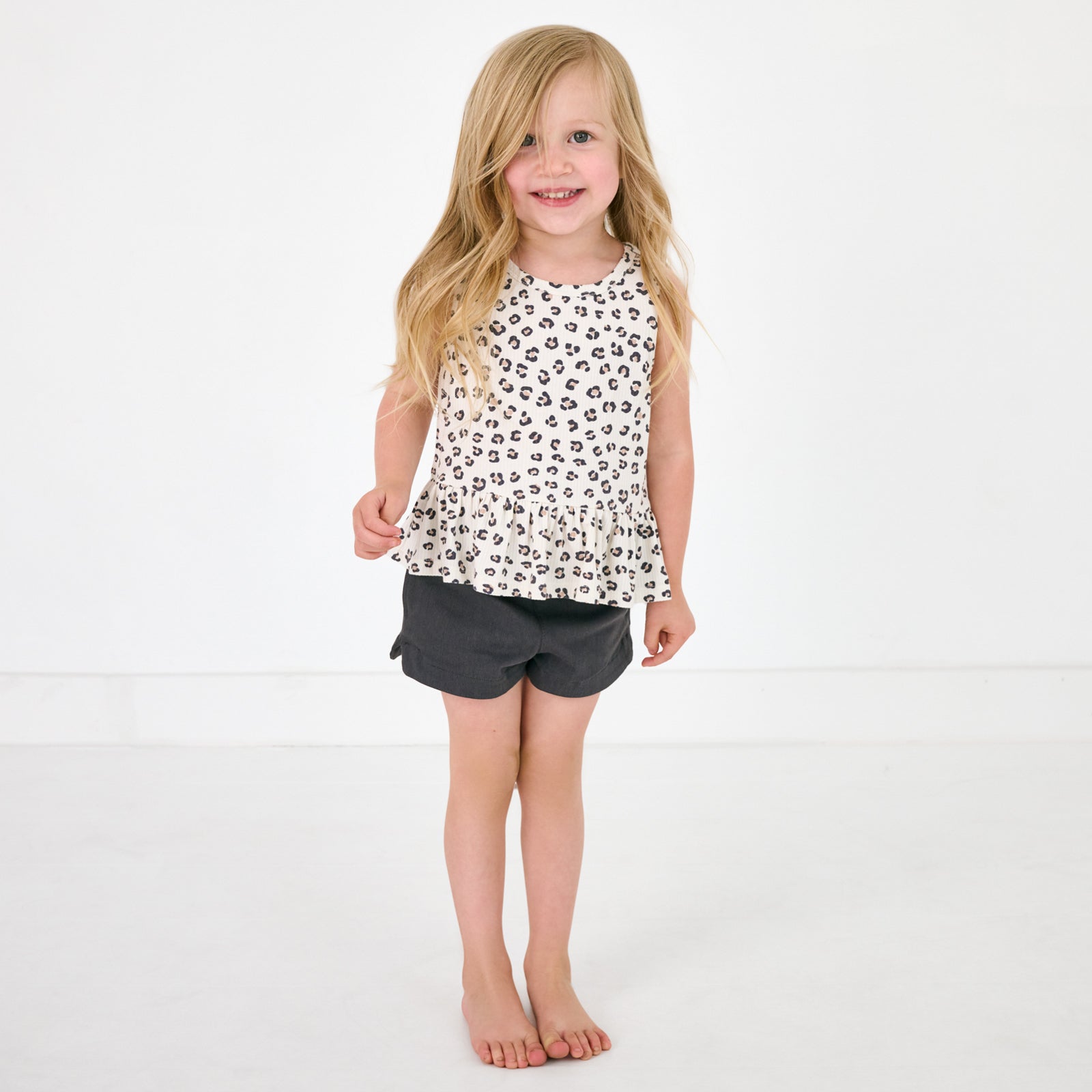 Standing child wearing the Washed Black Denim Shorts