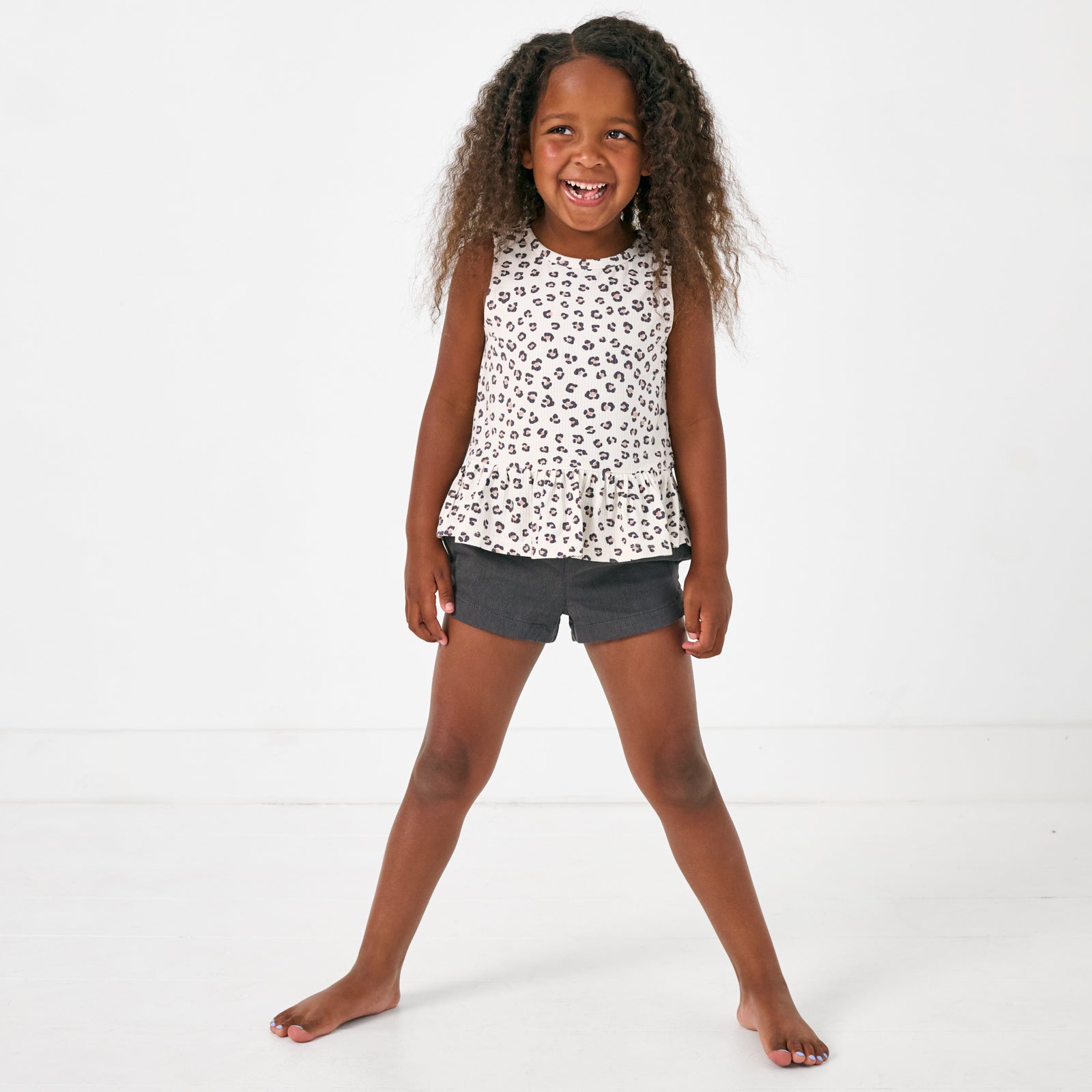 Standing child wearing the Washed Black Denim Shorts