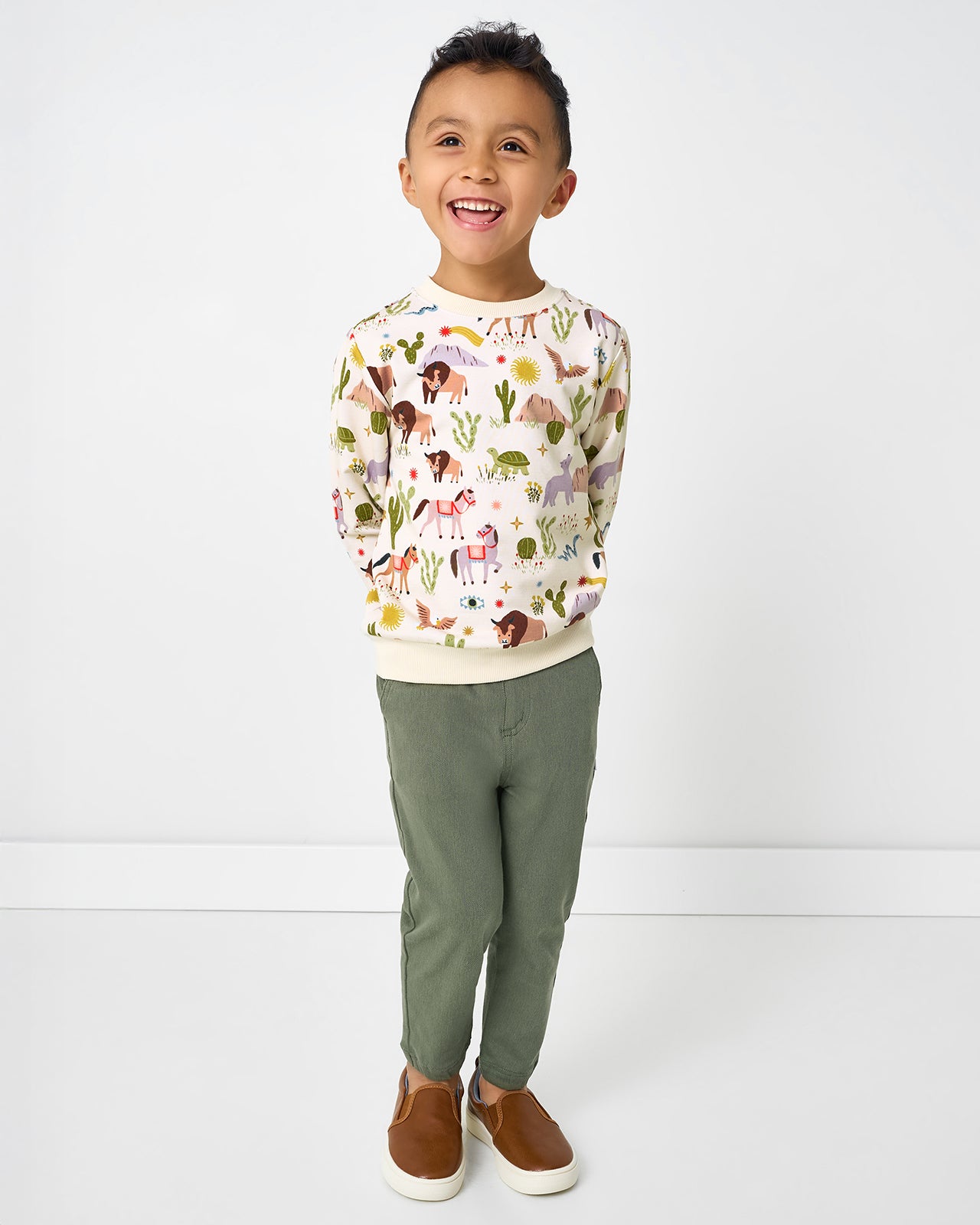 Boy wearing the Wild Frontier Crewneck Sweatshirt with green pants