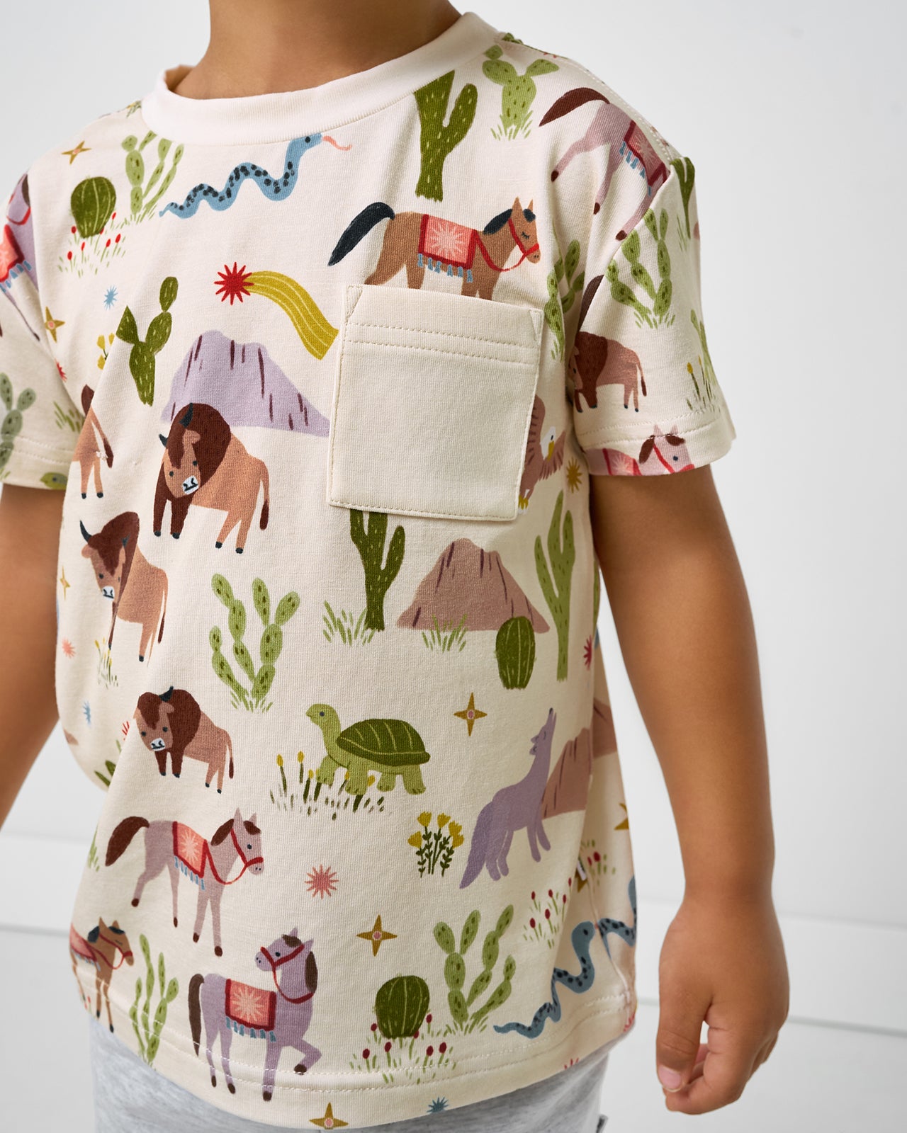 Close up of boy wearing the Wild Frontier Relaxed Pocket Tee