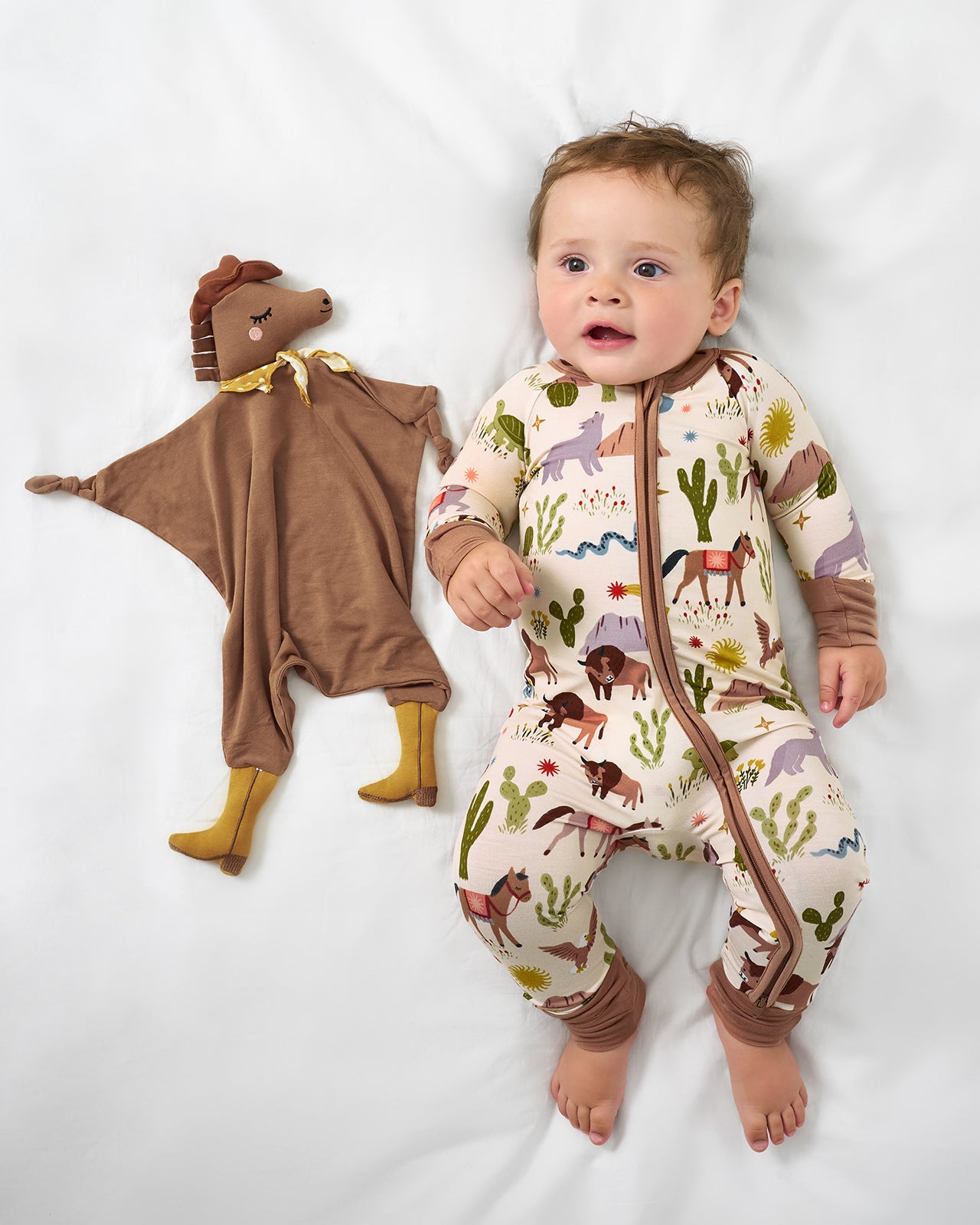 Baby laying with the Harley the Horse Sleepyhead Lovey