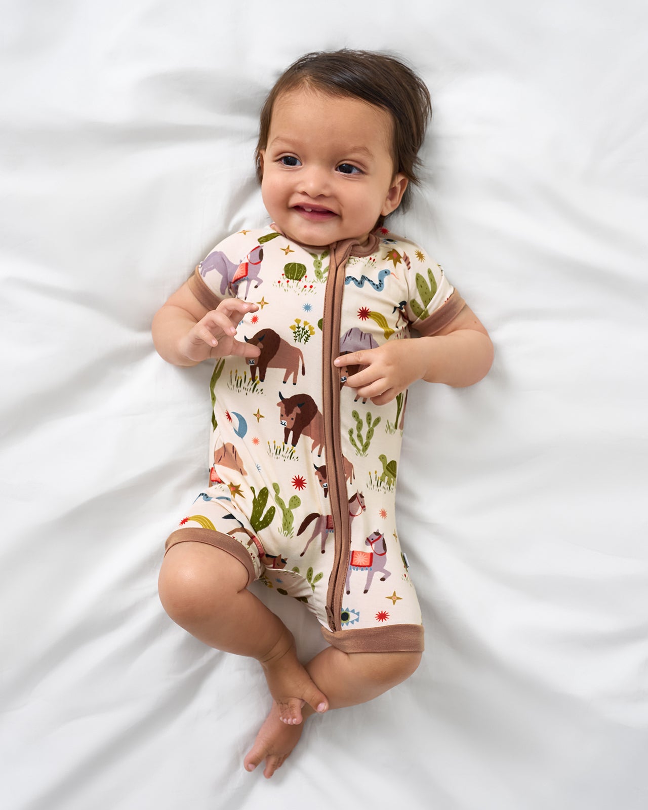 Alternate aerial view of baby wearing the Wild Frontier Shorty Zippy