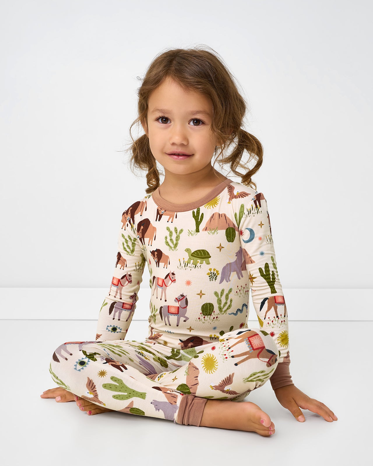 Sitting girl wearing the Wild Frontier Two-Piece Pajama Set