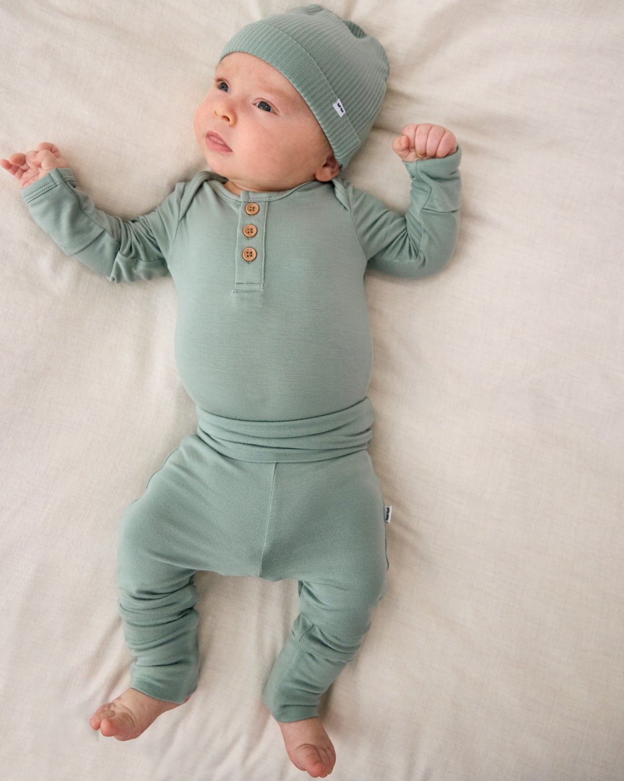 Baby wearing the Willow Fold-Over Legging with a matching newborn henley bodysuit