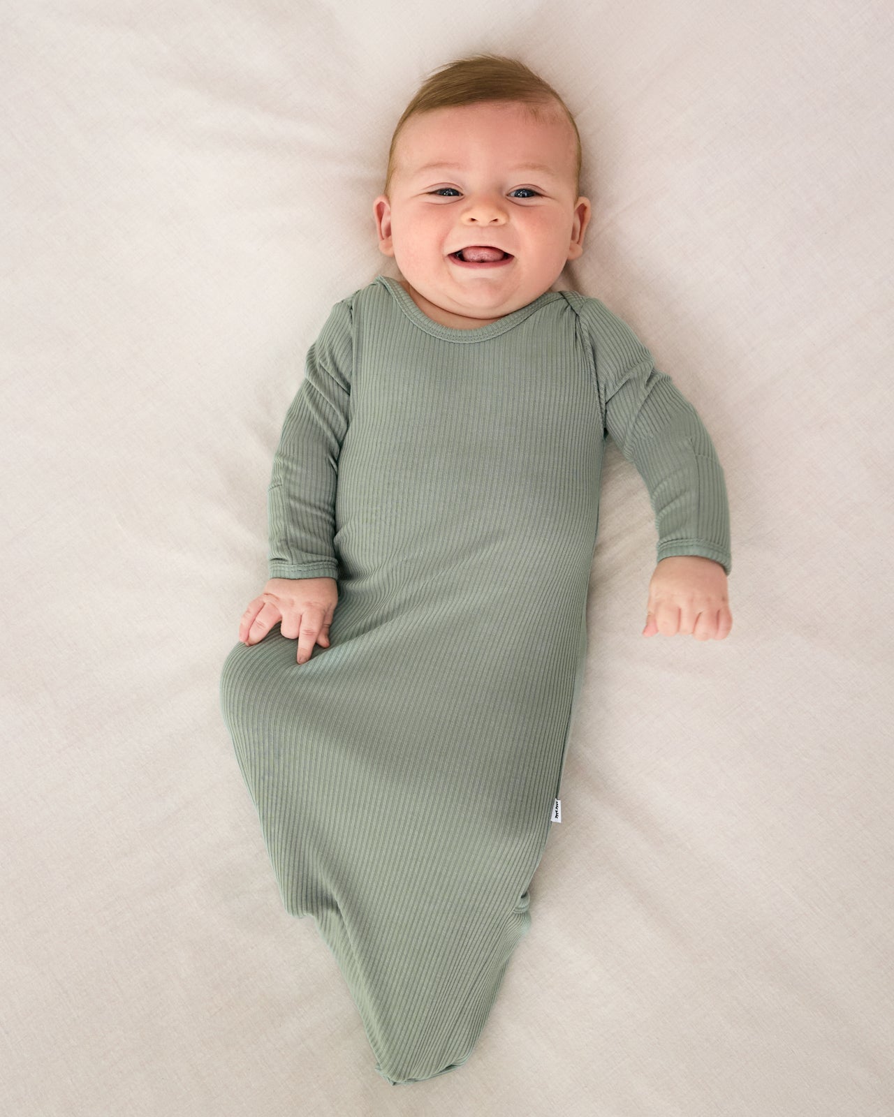Aerial view of newborn wearing the Willow Ribbed Infant Gown