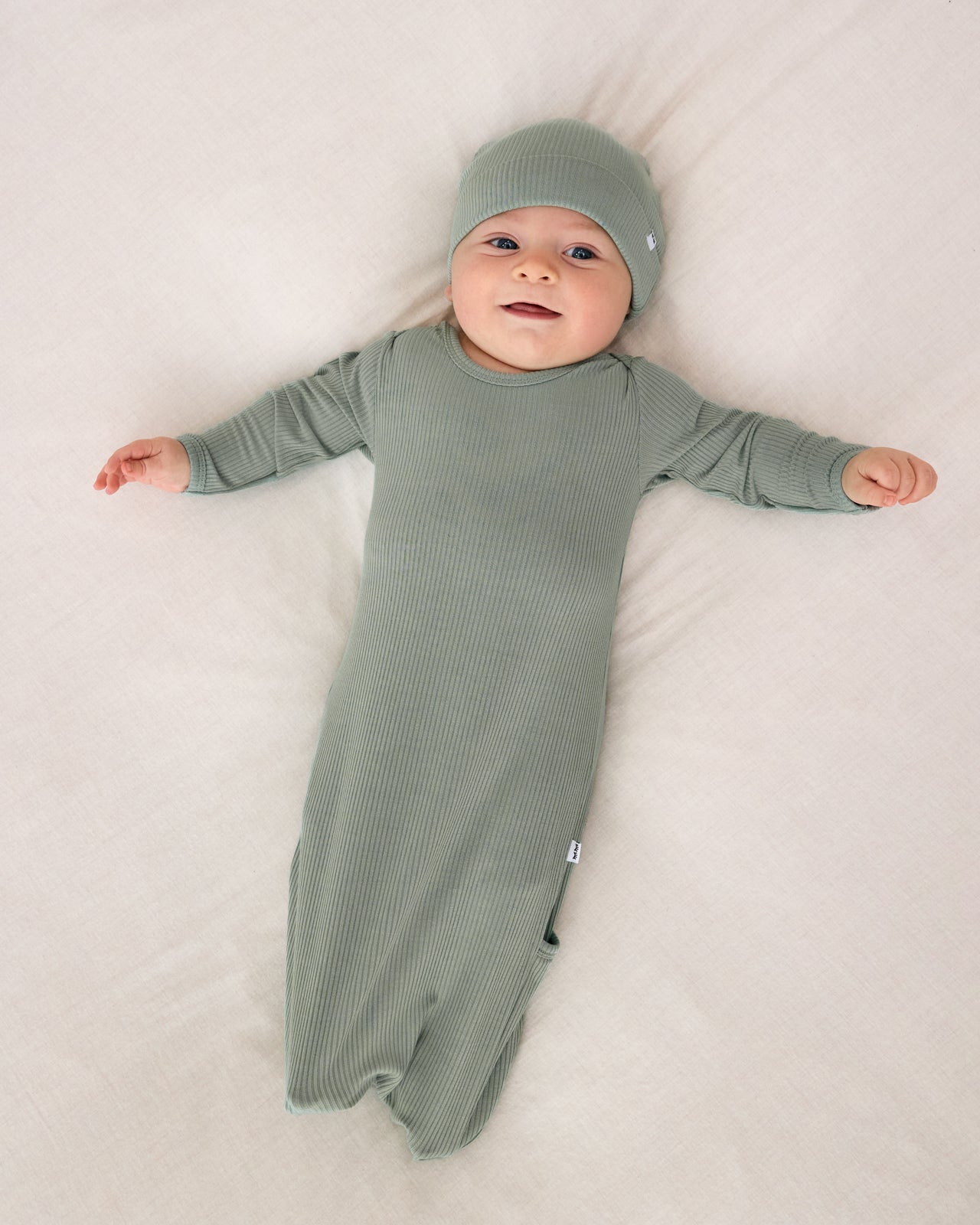 Aerial view of baby wearing the Willow Ribbed Infant Gown and matching beanie