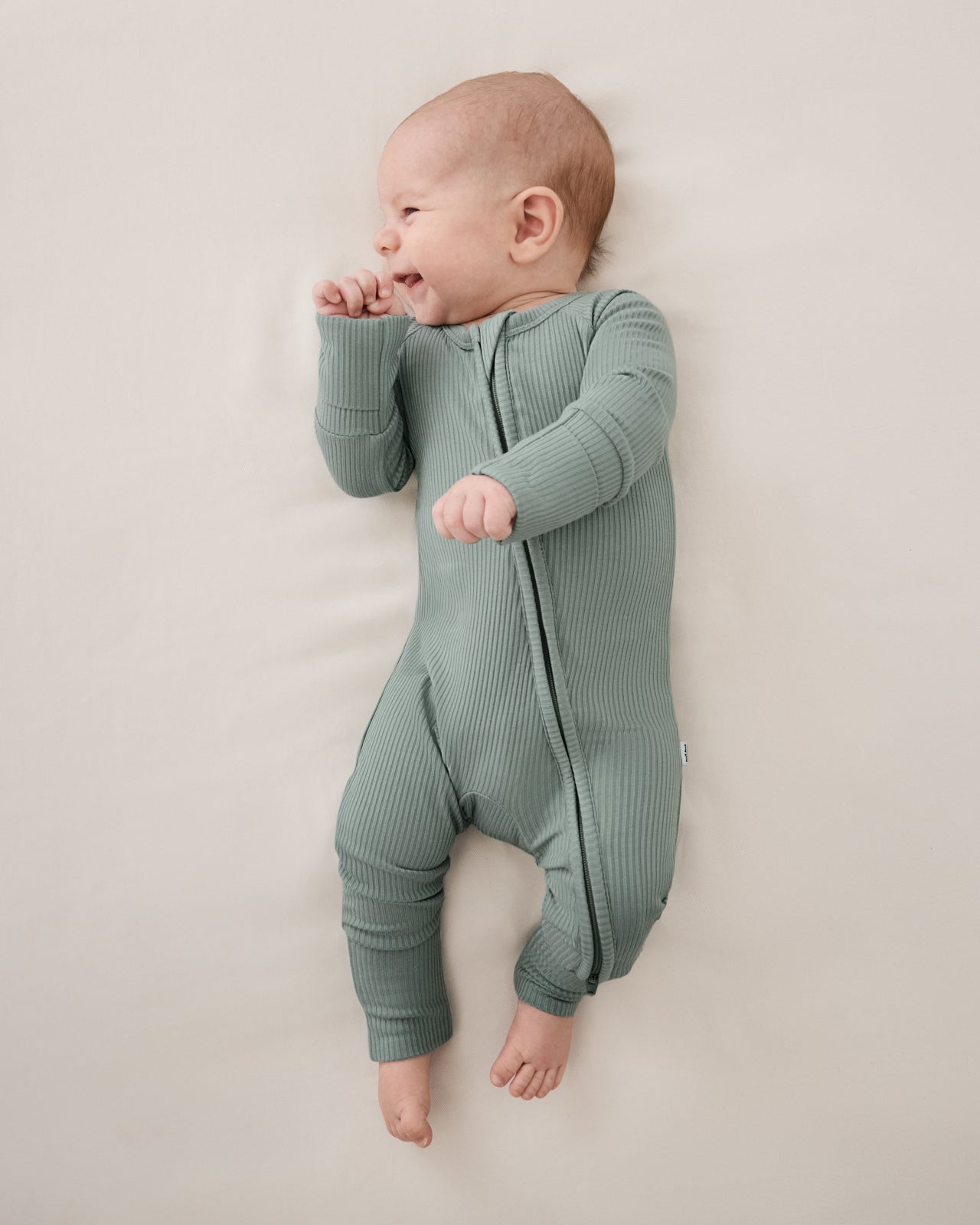 Aerial view of baby wearing the Willow Ribbed Zippy