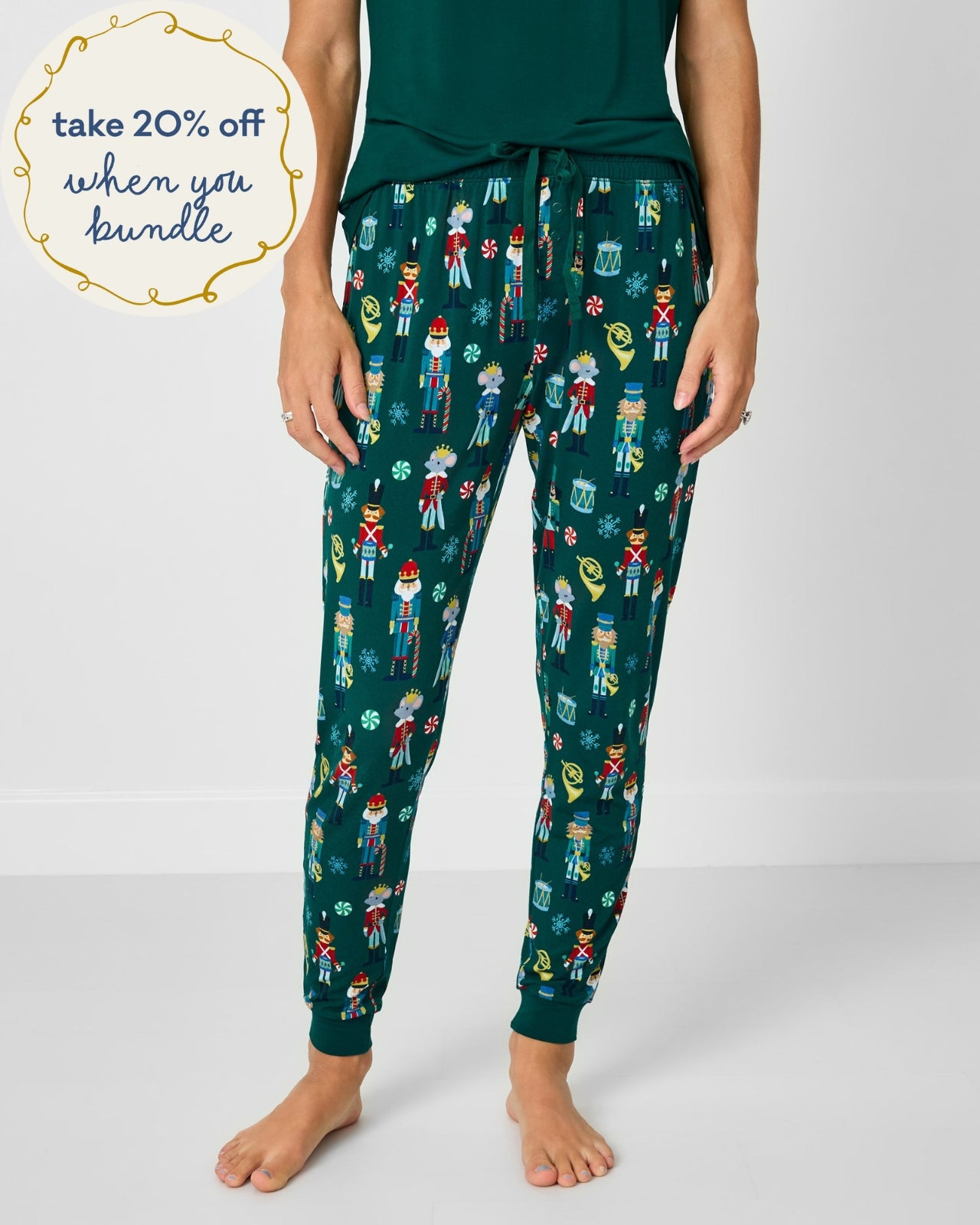 Woman wearing the Nutcracker March Women's Pajama Pants with a green pajama top