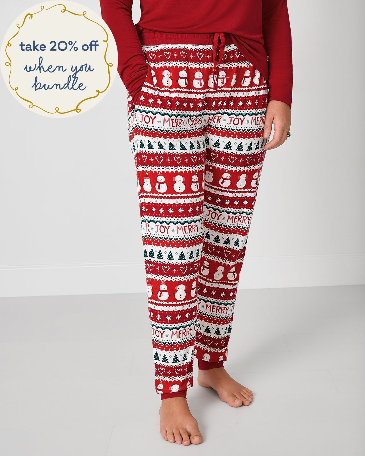 Woman wearing the Festive Fair Isle Women's Pajama Pants with a red pajama top