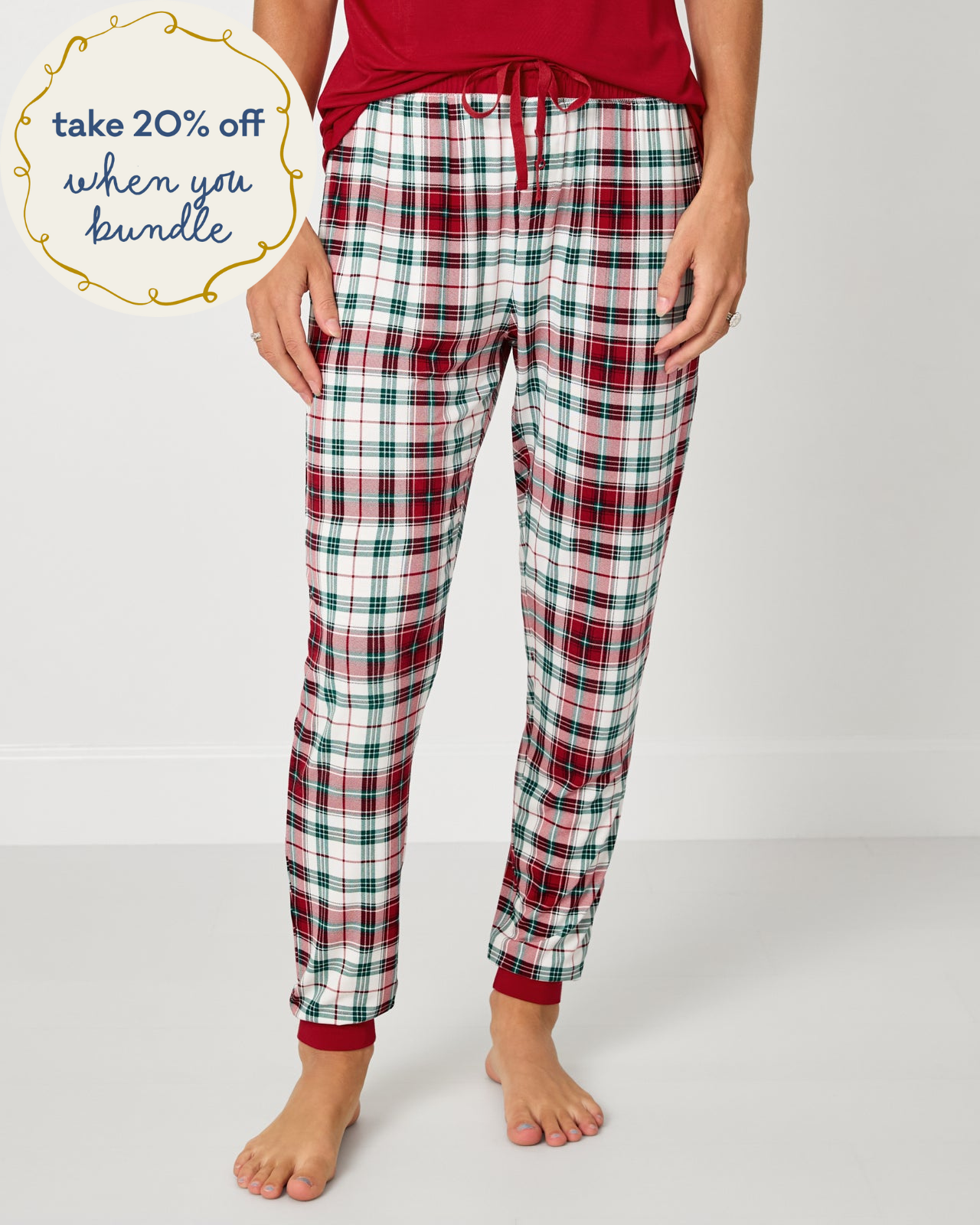 Woman wearing the Holly Plaid Women's Pajama Pants with a red pajama top