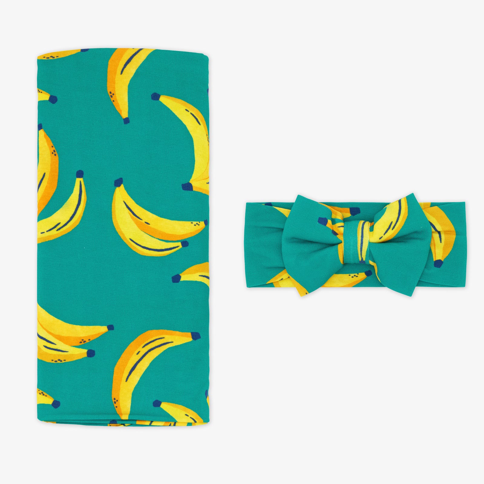 Flat lay of the Go Bananas Swaddle & Luxe Bow Headband Set