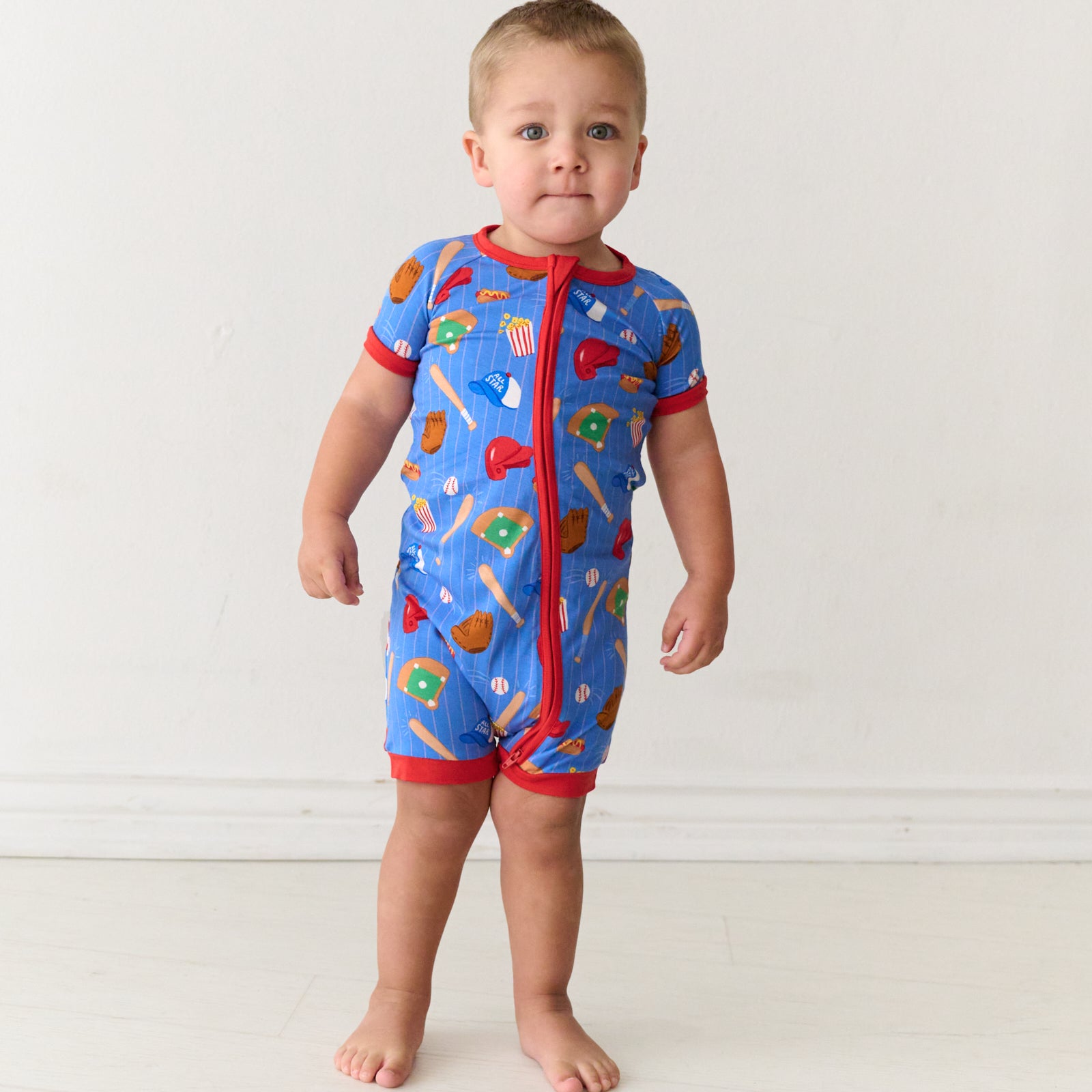 Standing toddler wearing a Blue All Stars bamboo shorty zippy