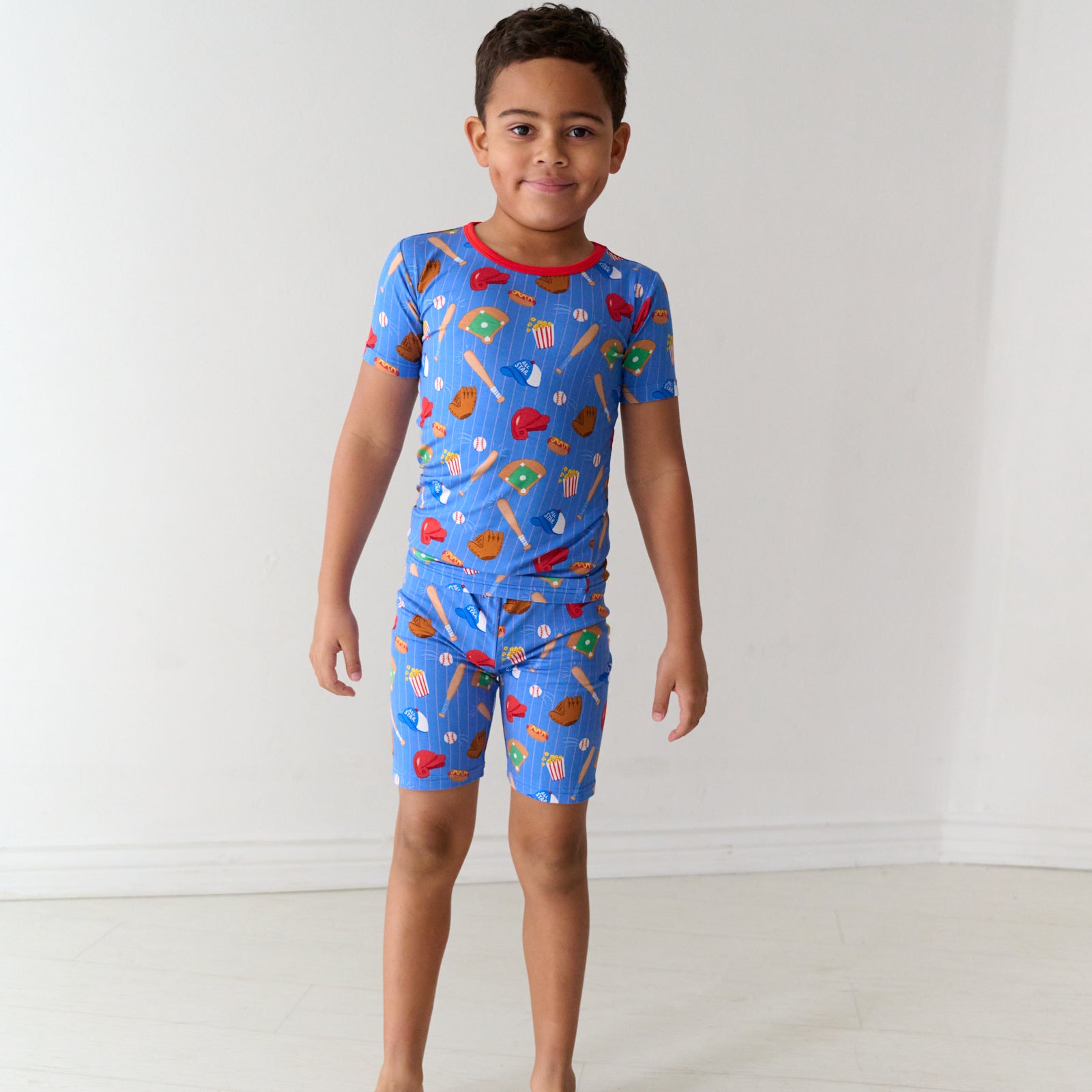Child wearing Blue All Stars two piece short sleeve and shorts bamboo pajama set