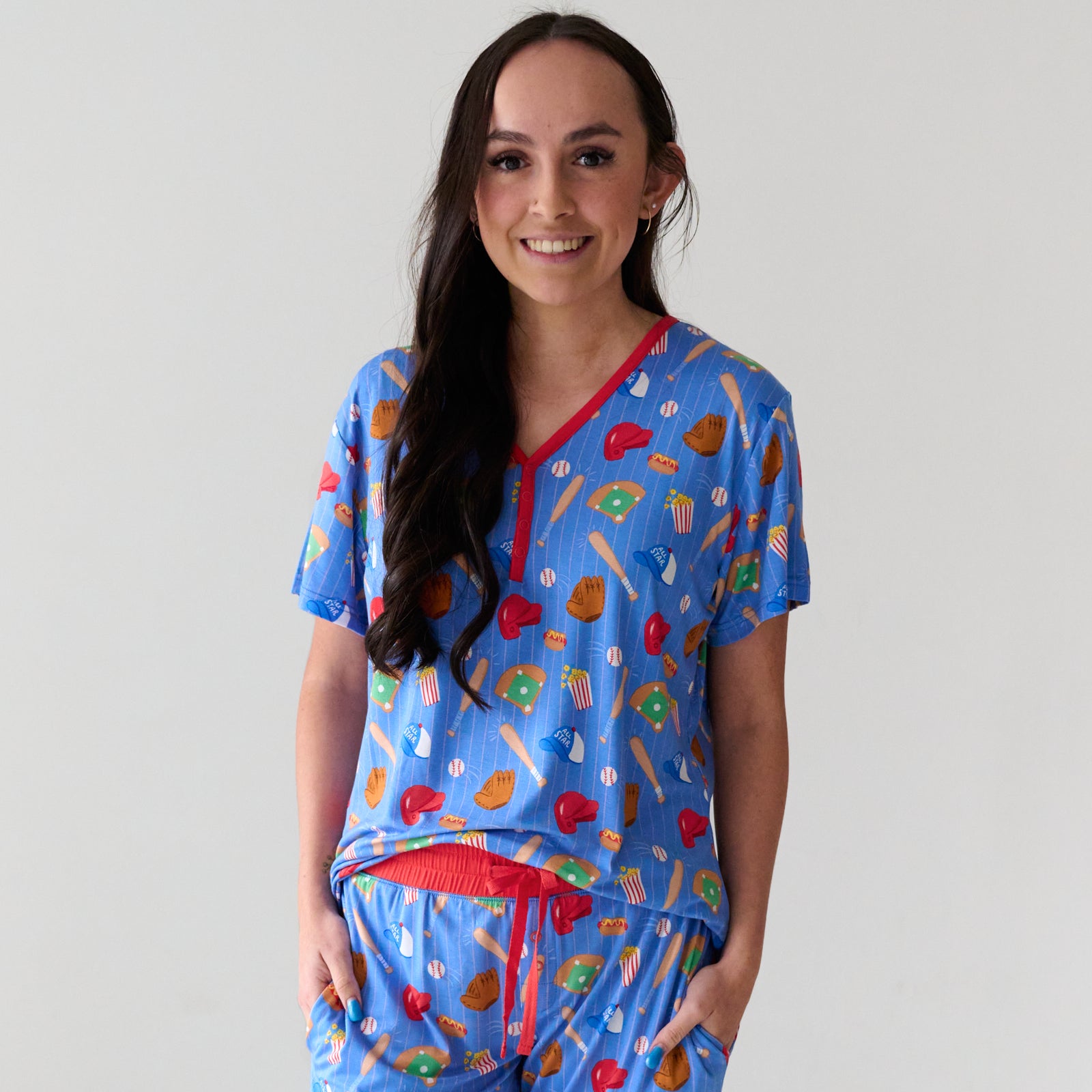 Close up of a smiling woman wearing a Blue All Stars short sleeve women's bamboo pajama top