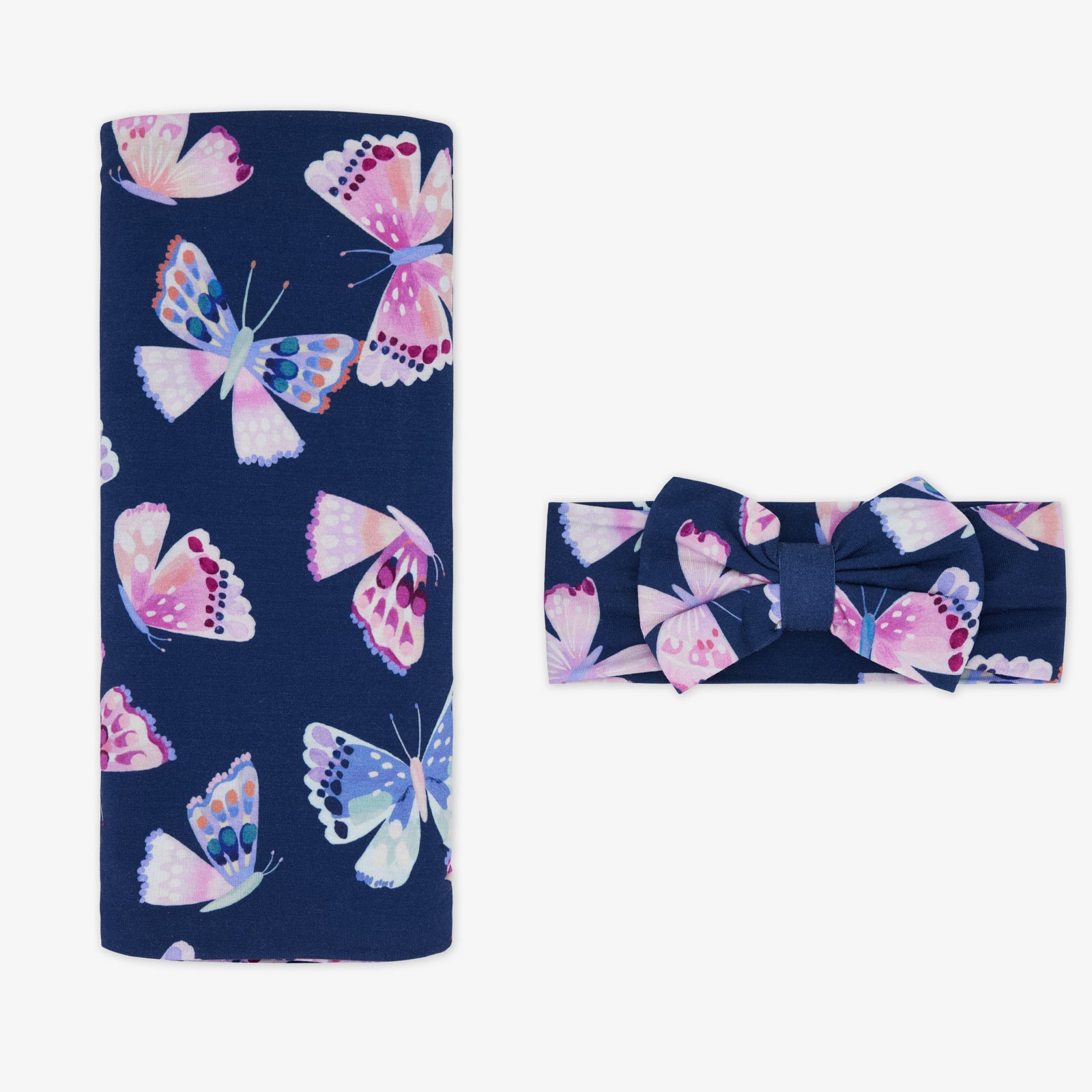 Flat lay of the Royal Butterflies Swaddle & Luxe Bow Headband Set