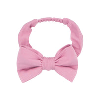 Flat lay image of a Garden Rose luxe bow headband size age 4 to age 8