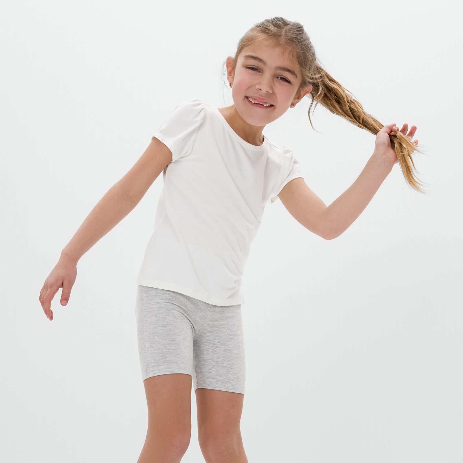 Close up of standing child wearing the Light Heather Gray Bike Shorts