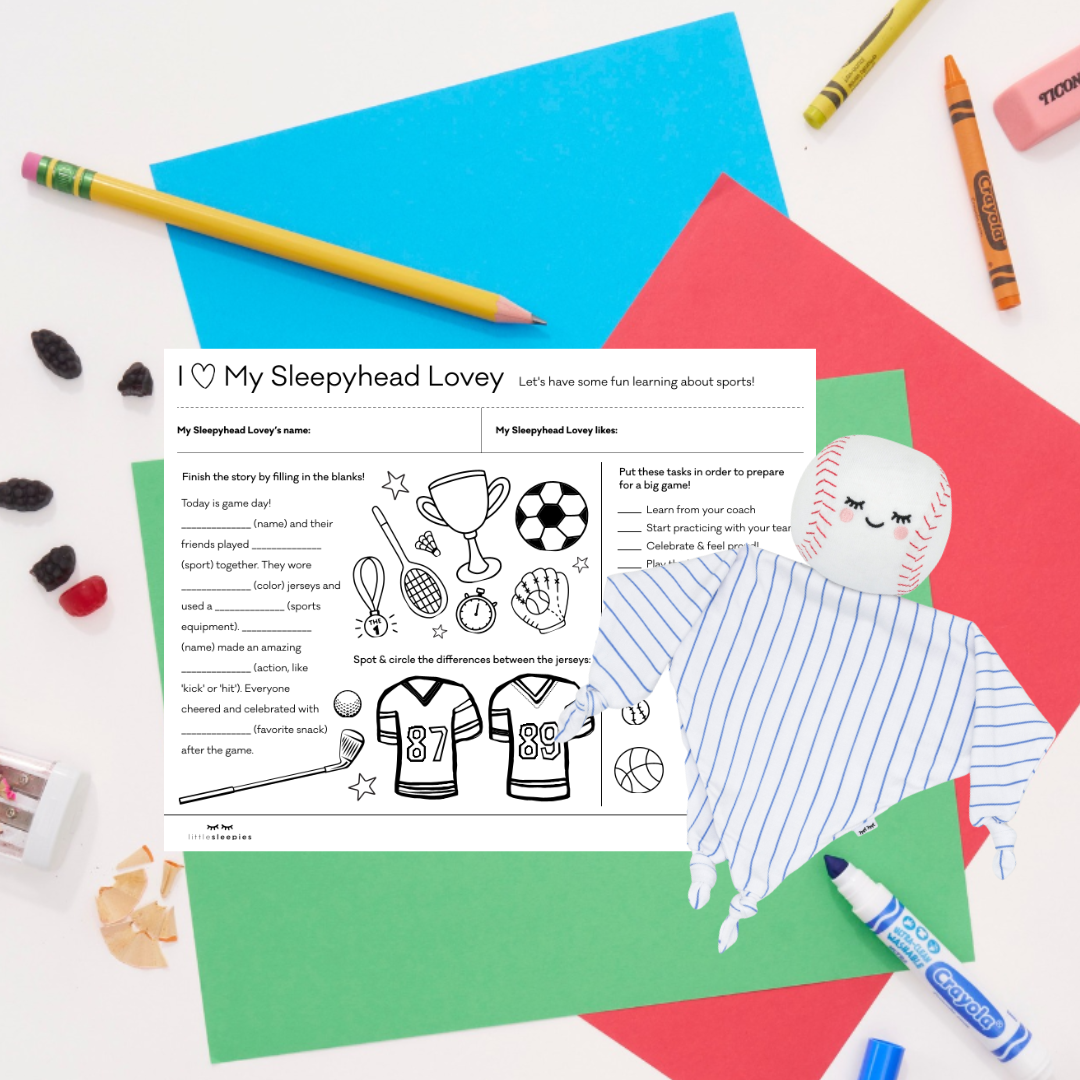 Major the Baseball Sleepyhead Lovey laying across a children's sports-themed activity sheet.