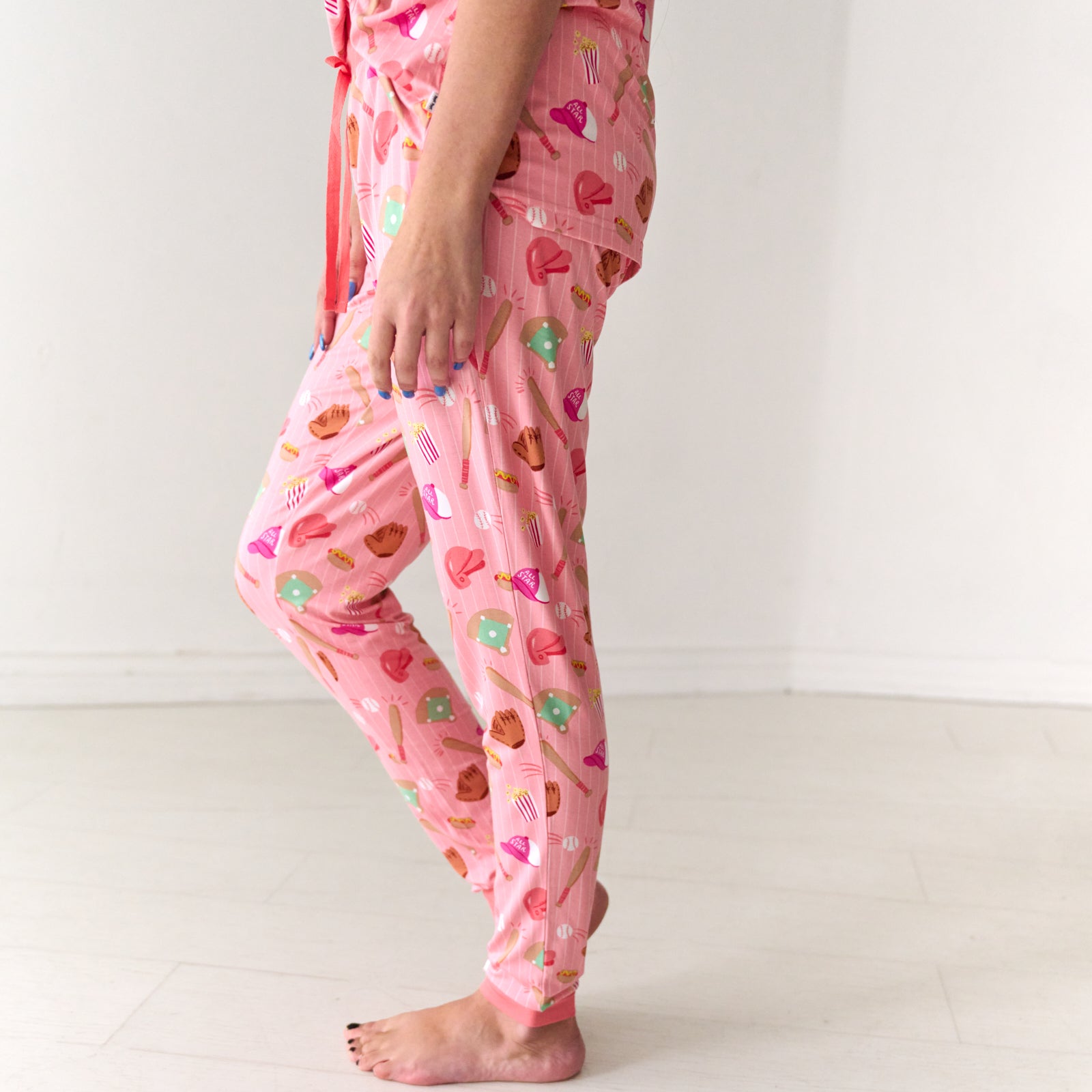 Close up profile view of a woman wearing Pink All Stars women's bamboo pajama pants
