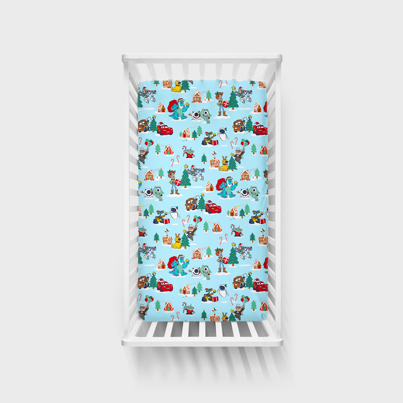 Overhead view of the Disney & Pixar Christmas Village Fitted Crib Sheet