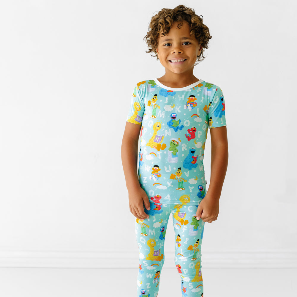 Child wearing a Spelling with Sesame Street two piece short sleeve pajama set