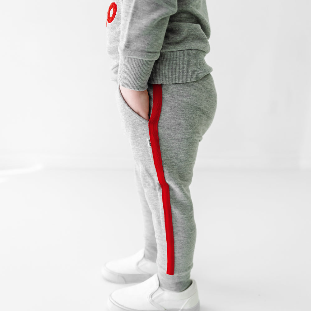 Side view image of a child wearing a Sesame Street Elmo crewneck sweatshirt and jogger set