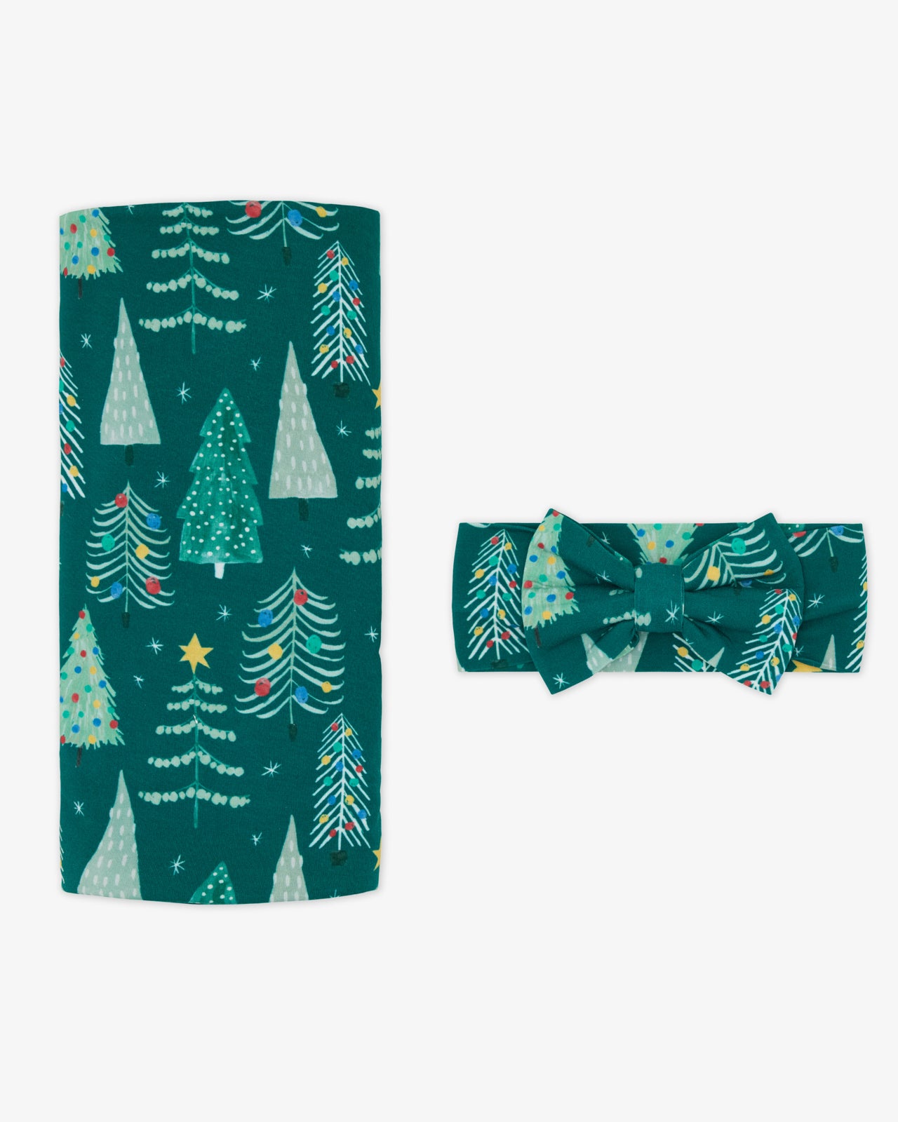 Flat lay of the Twinkling Trees Swaddle & Luxe Bow Headband Set