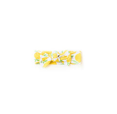 Image of Lemons printed bow headband. This print features vibrant pops of yellow fruit with green accents.