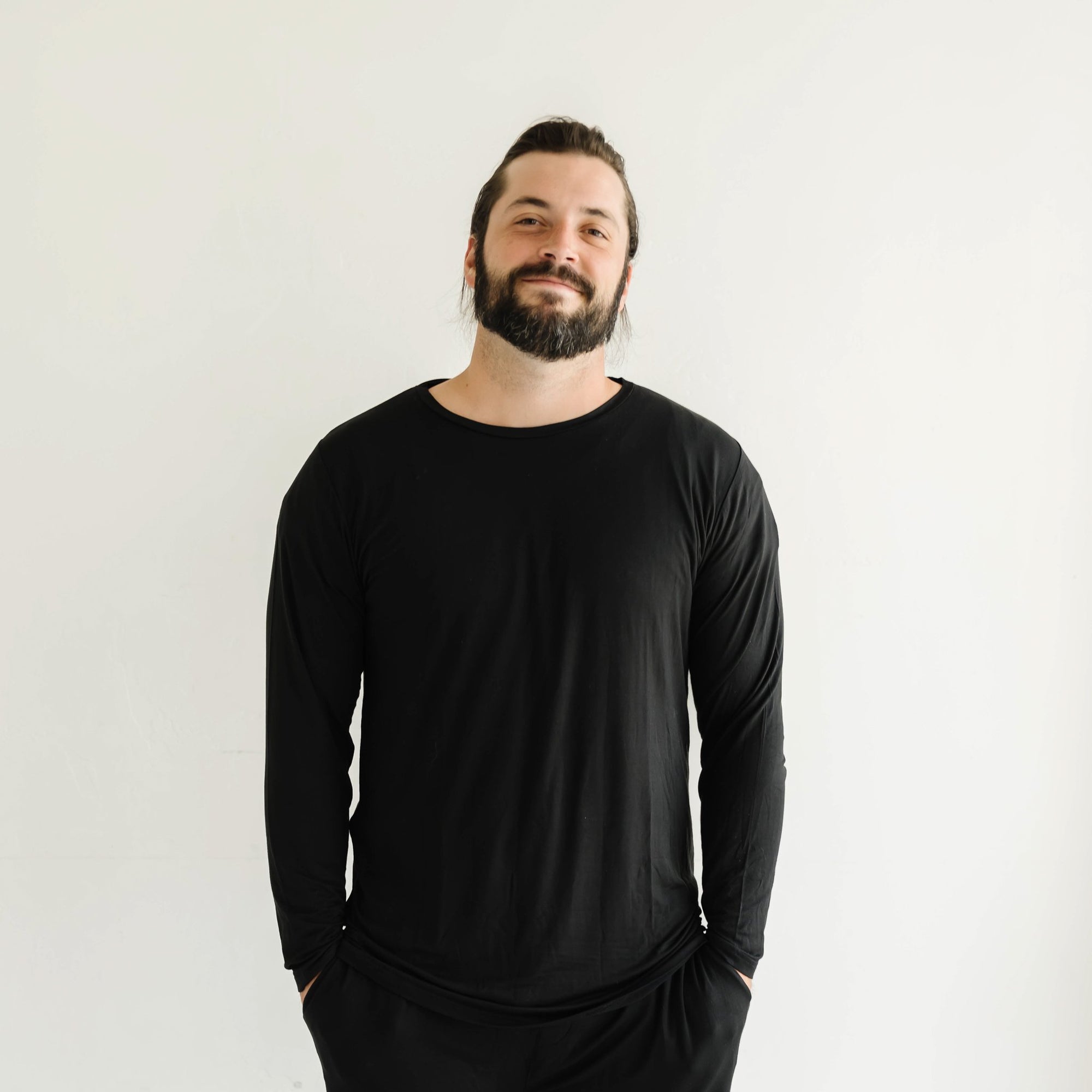 Image of male model wearing a solid black long sleeve pajama top