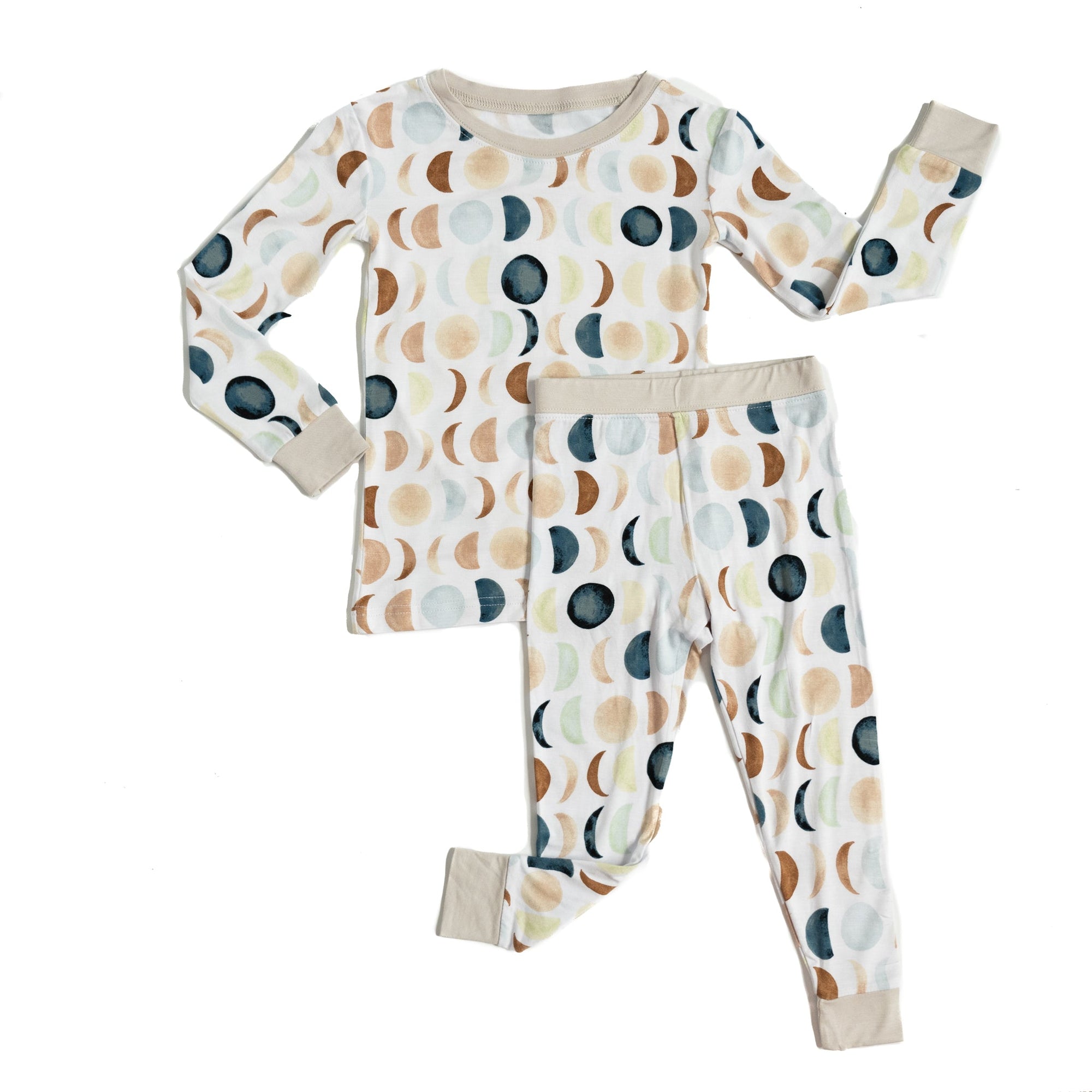 Flat lay image of a two piece long sleeve and pant pajama set in Luna Neutral print. This print features phases of the moon in the sweetest shades of creams, tans, and navy watercolor in an all over repeat pattern.