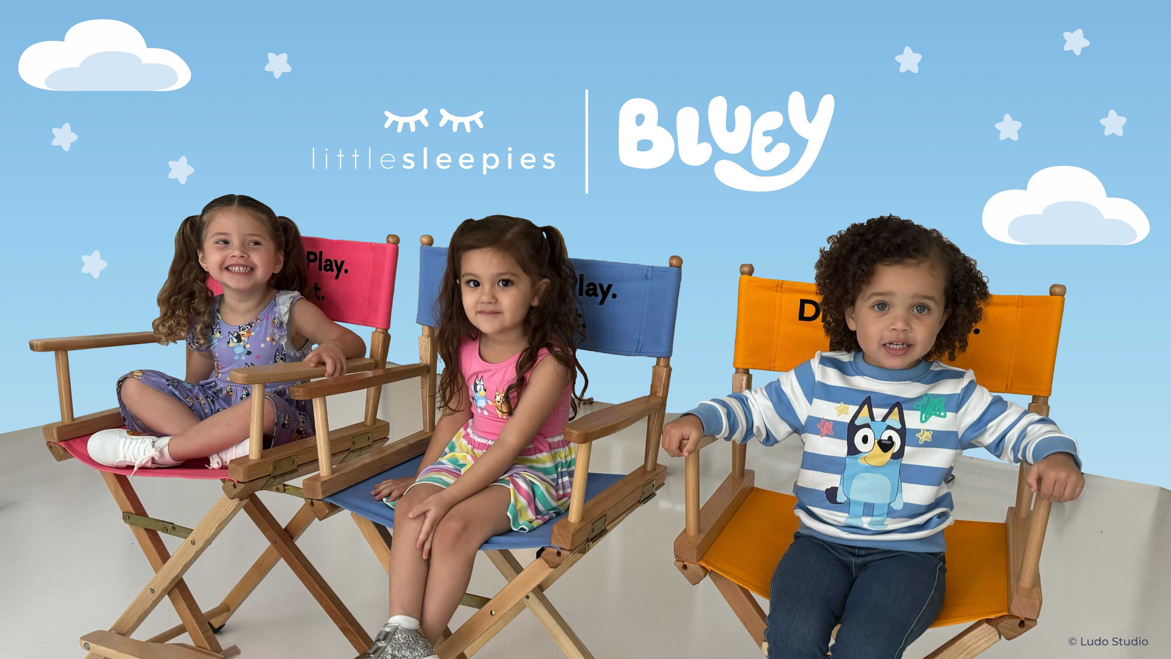 Three children sitting in chairs with a Bluey background