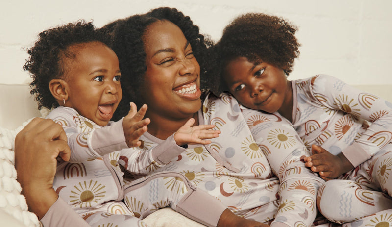 Mother and two children wearing matching Desert Sunrise pajamas