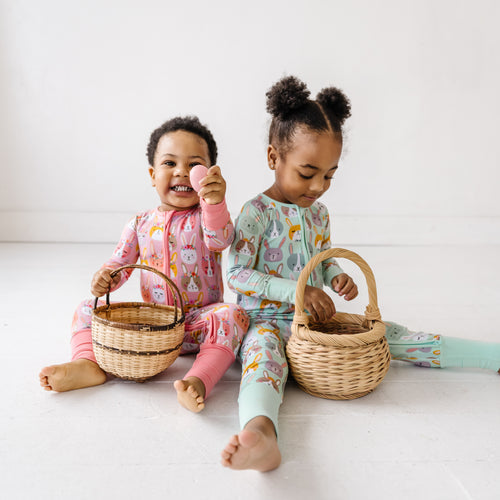 two little girls in easter pajamas with easter baskets