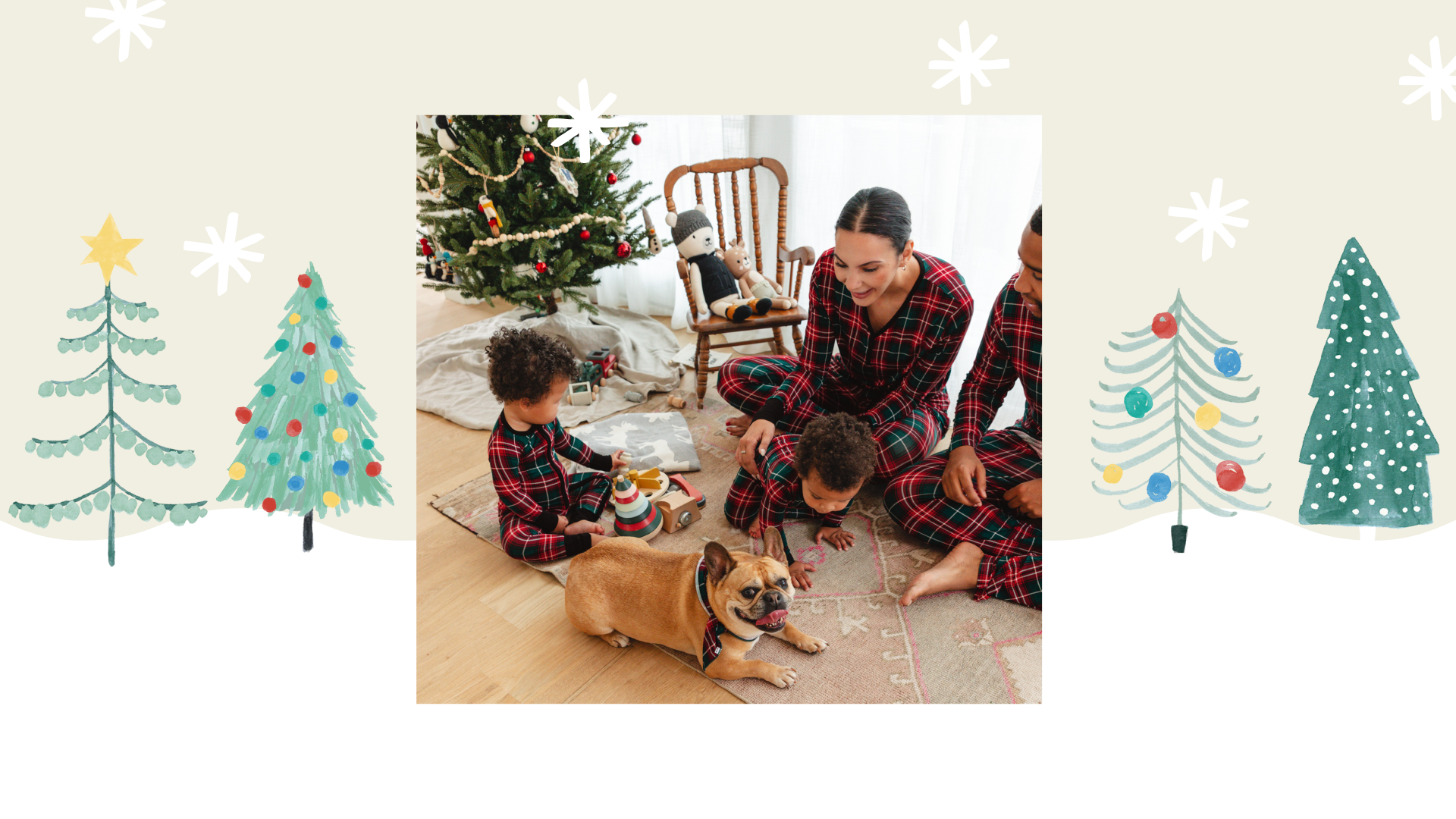 Family sitting on the ground wearing Fireside Plaid pajamas
