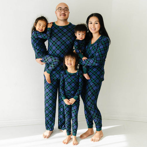 family of five wearing matching pajamas