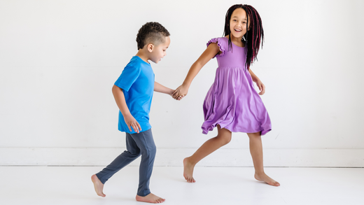 two children holding hands and playing