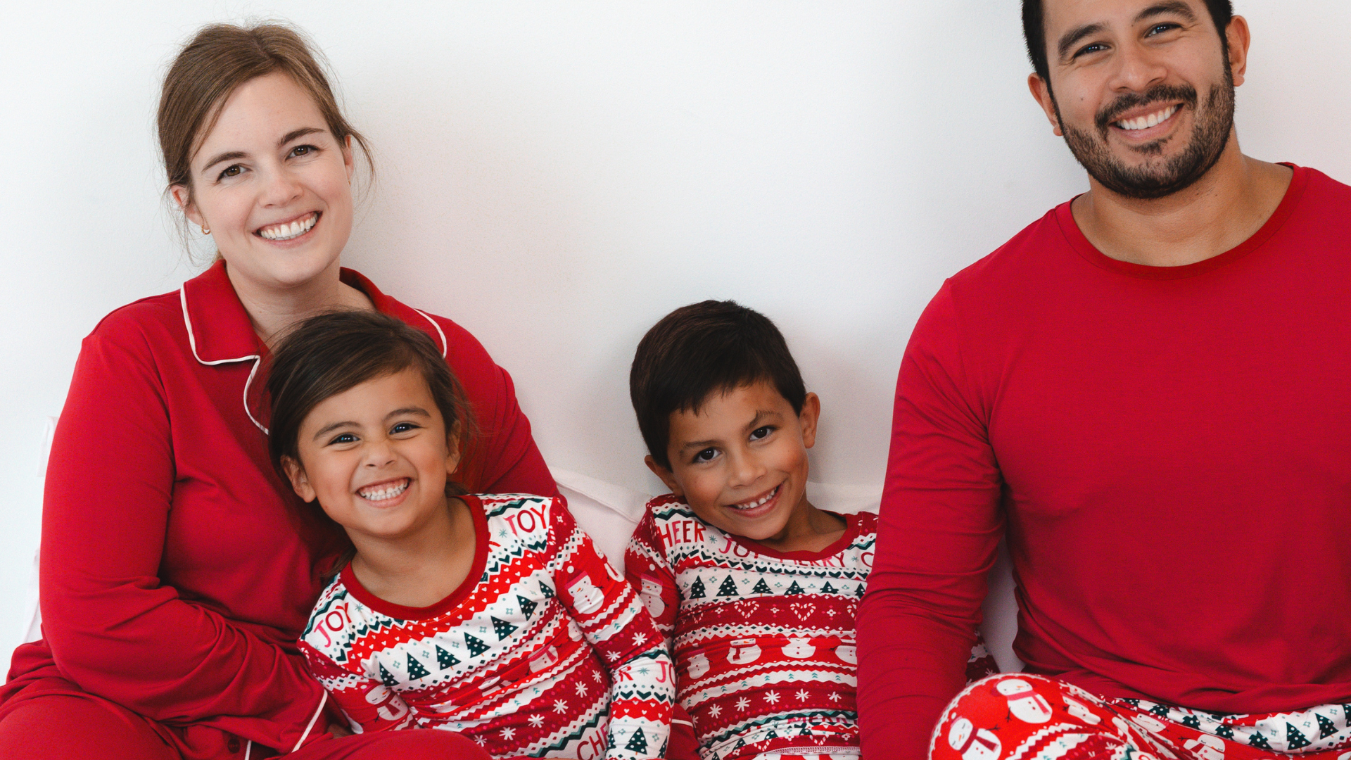 family of four wearing matching christmas pajamas