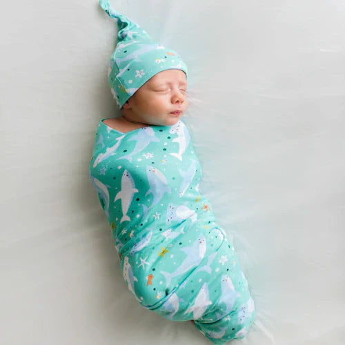 infant swaddled in a shark soiree swaddle & hat set