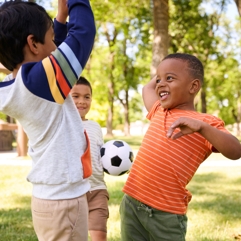 Children playing wearing various Striped play items