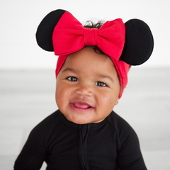 child wearing a minnie mouse red luxe bow headband