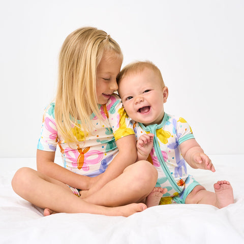 Two children wearing matching Balloon Bash pjs
