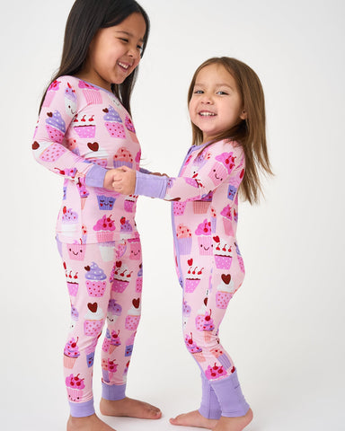 Two kids wearing cupcake kisses pjs