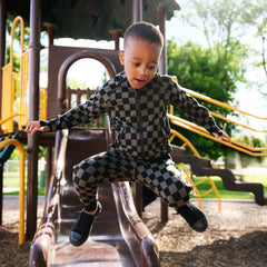 child playing wearing a Monochrome zip hoodie and matching joggers