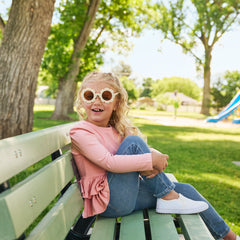 Child wearing Mauve Blush Ribbed tiered Peplum top and midwash blue leggings