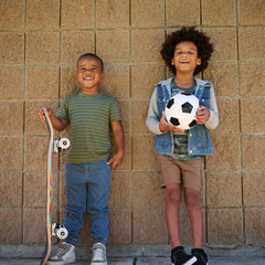 two children wearing coordinating outfits that include midwash blue denim joggers and jacket