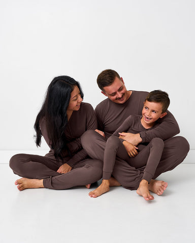 Family of three wearing brown pajamas