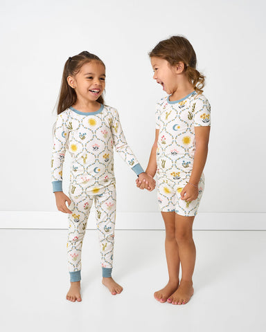 two girls wearing matching desert meadow two piece pajama sets