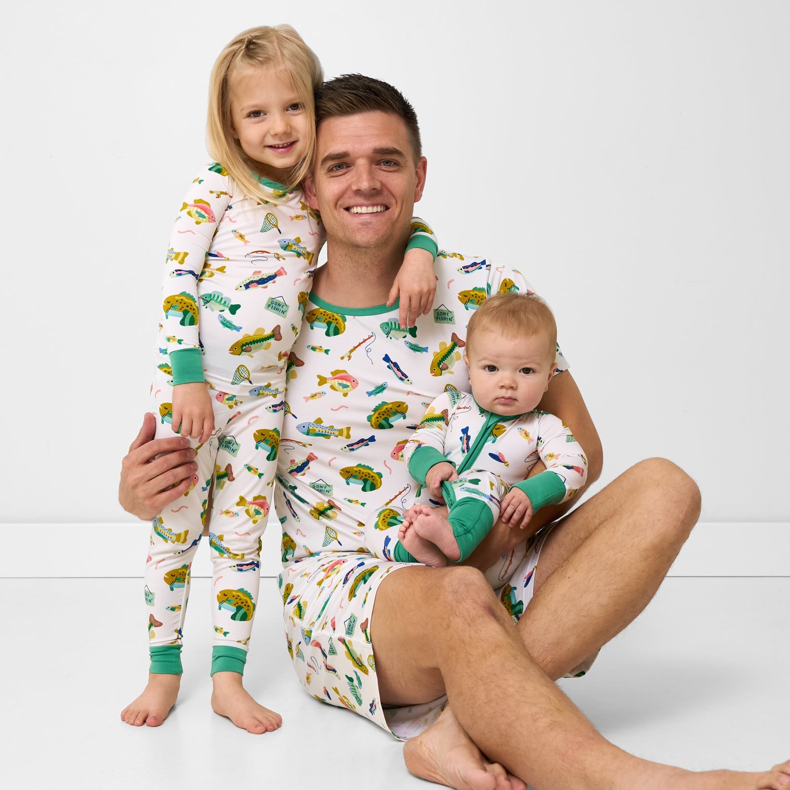 Father and two children wearing Gone Fishin' pajamas